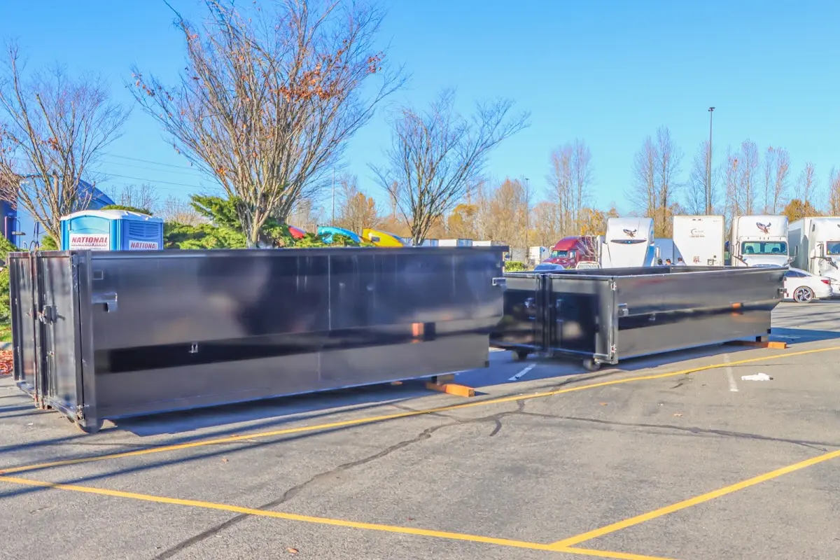 Professional dumpster rental service with roll-off container on residential driveway in Lower Merion